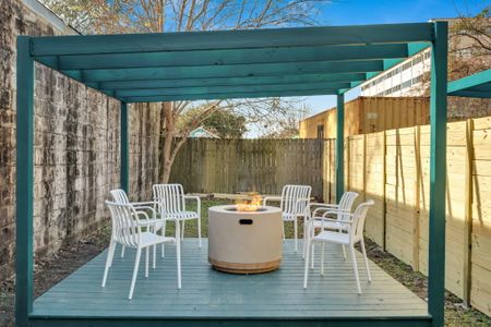 Outdoor courtyard w/ a firepit & dining set — ideal for laid-back evenings under the open sky.