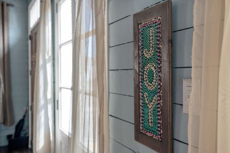 Carved wooden door panel adding a rich, artistic touch to the space.