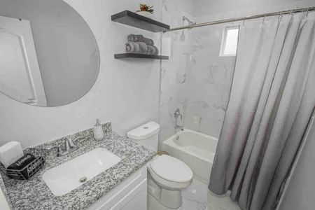 Clean bathroom w/ makeup towels & hair dryer ready for your morning routine.