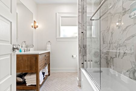 Bright bathroom w/ walk-in shower & clean, modern finishes.