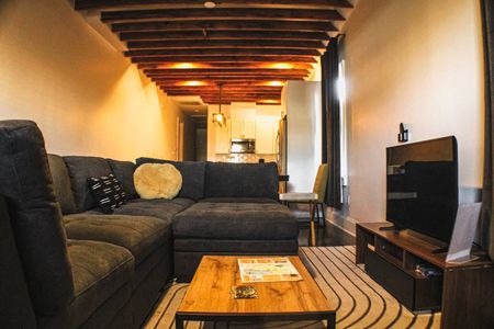 Warm, inviting living space w/ rich wood tones & cozy seating for the whole group.