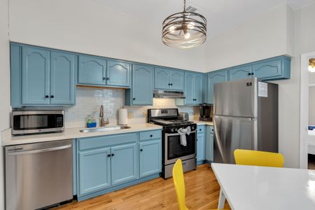 Cheerful blue kitchen w/ stainless appliances & plenty of counter space to cook up a meal.