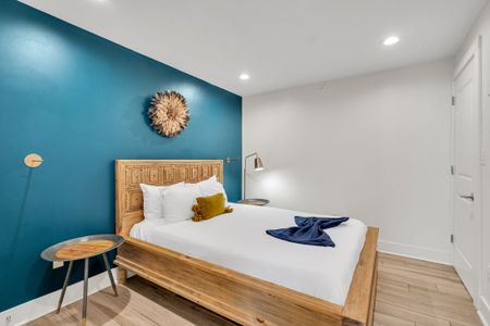 This spacious room features a king-size bed, fresh linens, and minimalist decor, creating a relaxing vibe after a day in NOLA.
