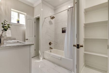 Clean, bright master en suite w/ tub & shower — everything you need.