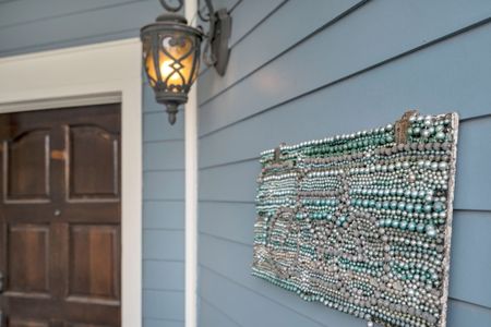 Welcoming porch with lantern lighting and local flair.