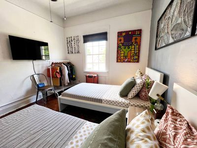 Second bedroom w/ two twin beds & colorful accents for a fun, relaxed stay.
