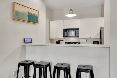Bright, clean kitchen w/ bar seating for casual meals or morning coffee.