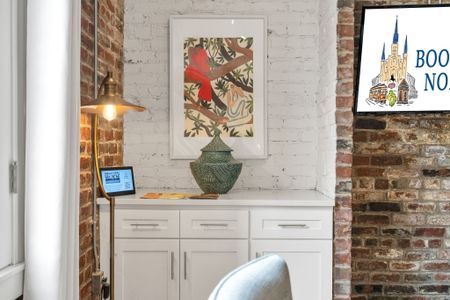 Cozy corner with local art and exposed brick—bringing New Orleans charm right into your stay.