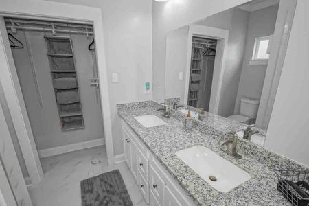 Bright bathroom w/ sink & ample counter space for a comfortable morning routine.