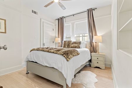 Airy bedroom w/ warm natural light, bold bedding & closet space included.