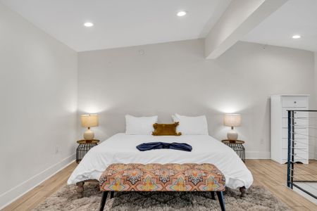 Sink into a plush bed with warm lighting and soft textures. This peaceful loft space is made for deep rest and quiet mornings.