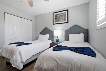 Second bedroom w/ twin beds & soft, calming décor for easy rest.