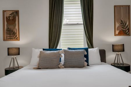 Cozy bed nook w/ teal accents & soft textiles that invite you to curl up.