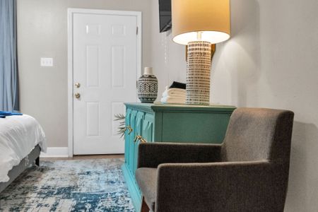 Charming entryway w/ a teal console & local décor to welcome you in style.