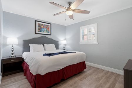 Restful bedroom w/ a cozy bed & charming courtyard-inspired accents.