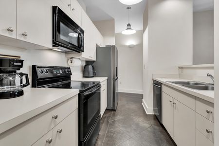 Fully equipped kitchen w/ stainless steel appliances ready for home-cooked meals.