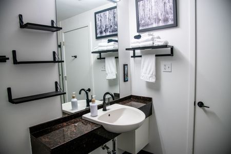 Bright bathroom w/ sink & modern fixtures — clean, simple & ready for your stay.