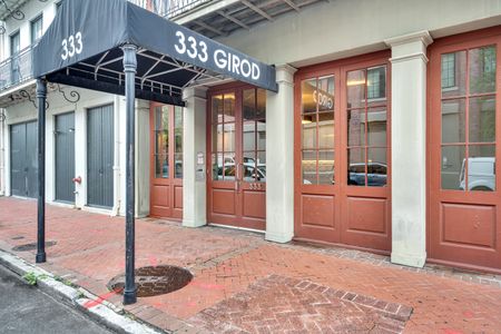 Step through the elegant wood & glass entrance of 333 Girod.