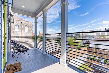 Covered balcony w/ open-air seating & sweeping city views.