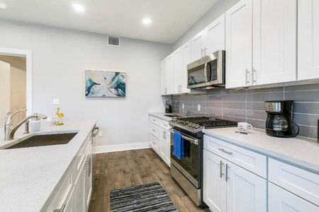 Stylish kitchen w/ subway tile backsplash, stainless range & plenty of counter space.