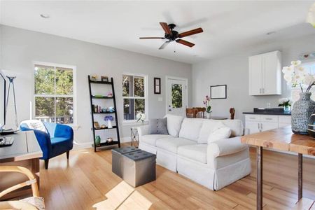 Relaxed living room w/ soft seating & natural light pouring in.