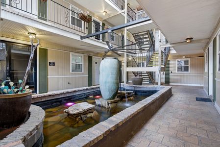 Serene courtyard w/ a decorative fountain adding a calming touch.