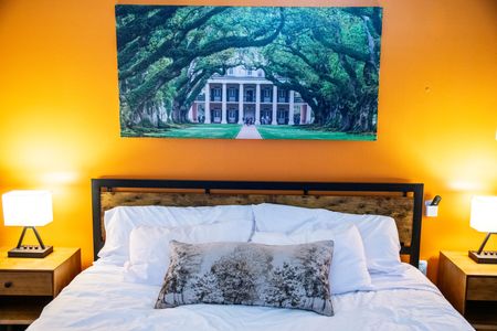 Drift off under soft lighting in this cozy, warmly decorated bedroom.