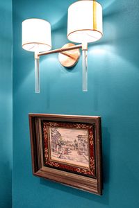 Rich teal accent wall w/ framed artwork that makes the room feel curated & bold.