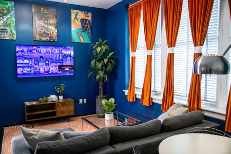Bold art, warm light & rich color — a living space that feels unmistakably New Orleans.