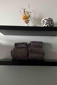 Neatly folded towels stacked & ready, so you can settle in & feel right at home.