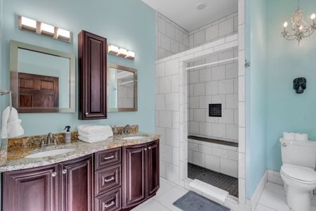 Bathroom w/ shower, elegant vanity & plenty of space to get ready.