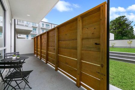 Enclosed outdoor patio w/ wood privacy fence — your own quiet retreat.