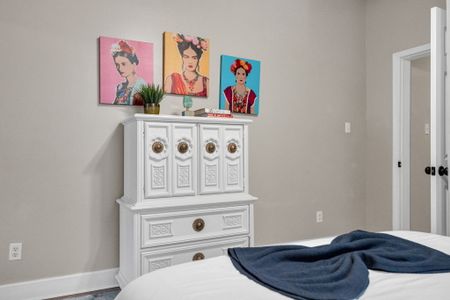 Dresser w/ curated décor & vibrant wall art adding personality to the space.