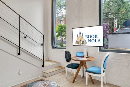 Bright desk nook w/ a city-themed print — ideal for catching up on work.