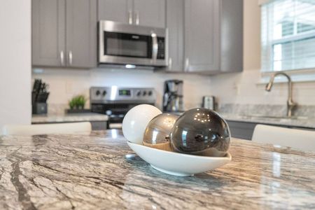 Sleek kitchen countertop w/ modern décor touches that elevate the whole space.
