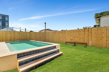 Fully-fenced pool w/ toys, towels & lounge chairs — sunny and ready for a swim.