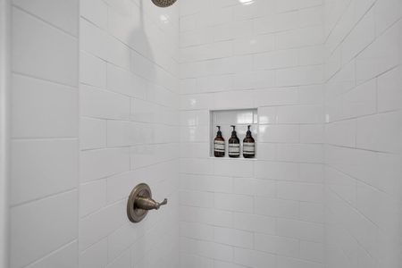 Second bathroom w/ shower & toiletries hook for a convenient, organized space.