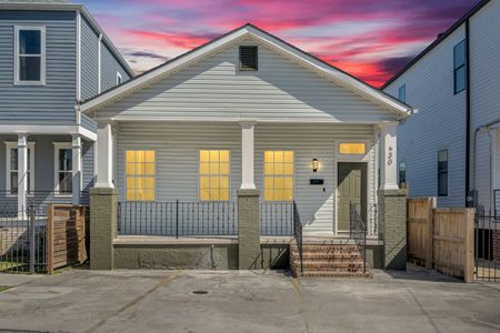Charming exterior w/ classic porch & glowing windows — a welcoming first impression.
