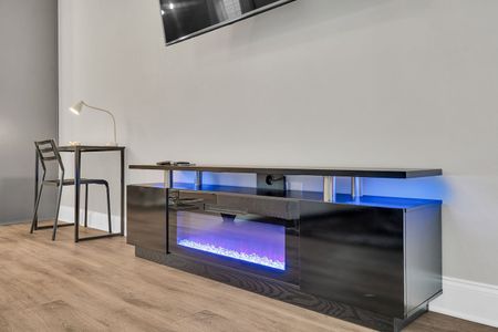 Sleek entertainment console w/ an electric fireplace for cozy evenings in.