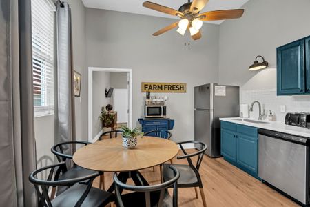 Sunny kitchen nook w/ a round table — perfect for morning coffee or a casual meal.