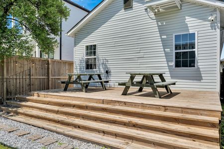 Sunny backyard deck w/ a picnic table — a great spot to dine or relax outdoors.