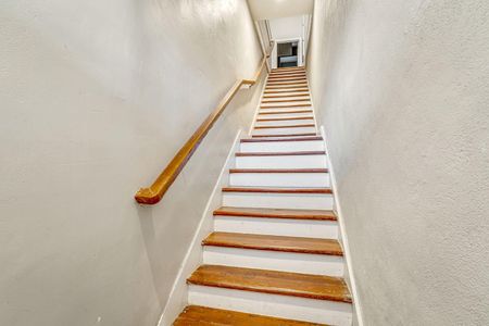 Classic wooden staircase leading up to the 2nd floor of the home.