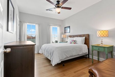Bright, airy bedroom w/ a cozy bed & plenty of natural light.