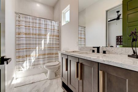 Jack & Jill bath w/ generous counter & cabinet space — perfect for sharing.