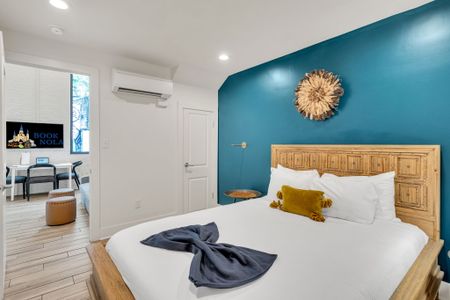 Rest easy in the tranquil bedroom featuring a comfortable queen-size bed, soft linens, and calming decor—your perfect retreat after a day exploring the French Quarter.