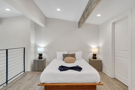 Sunlit loft bedroom where morning light spills in for a bright, airy wake-up.