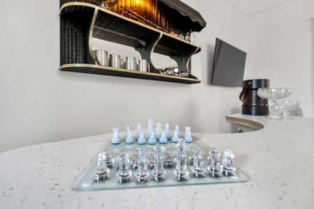 Curated bar shelf stocked w/ glassware & everything you need to mix a great drink.