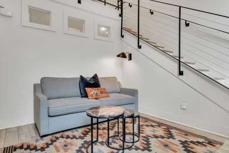 Cozy seating nook w/ chic décor & natural light — a perfect spot to relax.