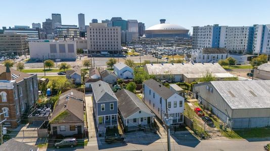 Aerial view showing the home nestled in a lively urban neighborhood.