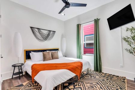 Downstairs king bedroom w/ bold orange & green accents for a vibrant vibe.